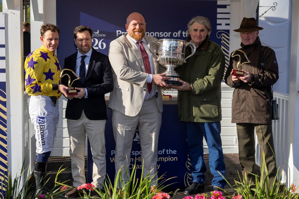 Paul Townend and Willie Mullins collect their trophies after winning the William Hill Champion Chase